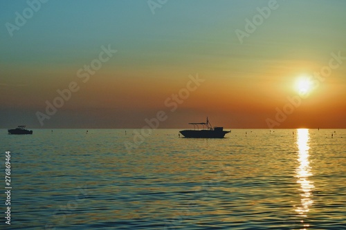 Sunset over Adriatic Sea. View from Golem / Durres, Albania. Beautiful sunset with two fishing boat silhouettes