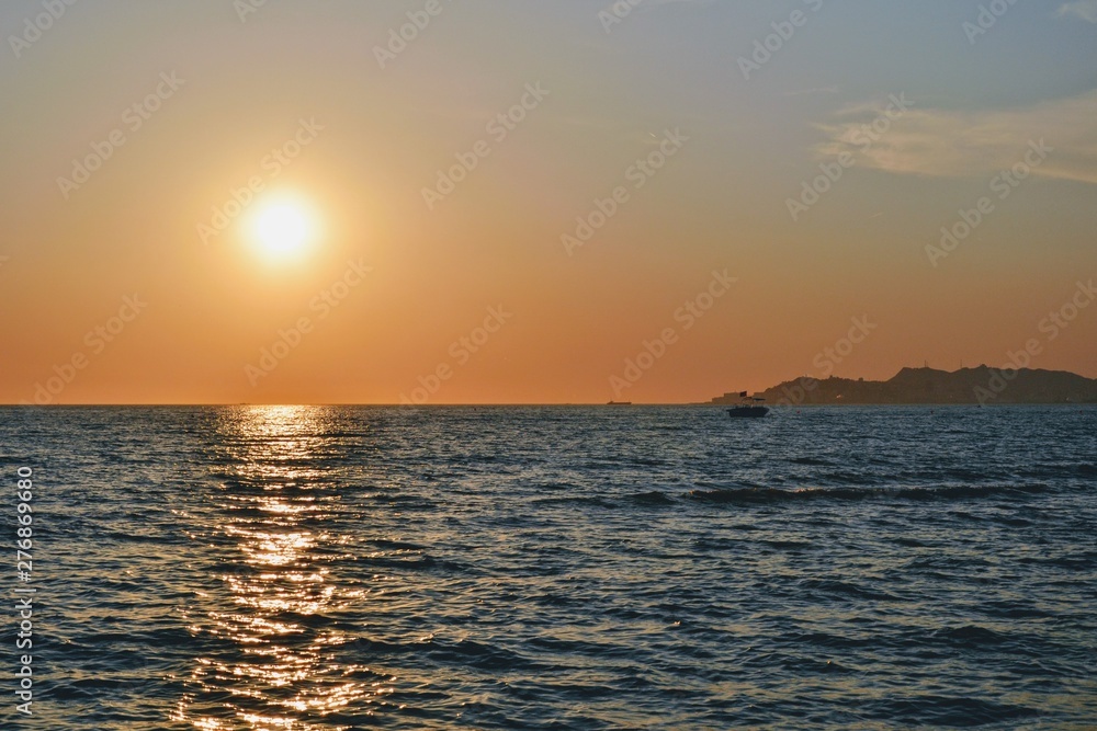 Sunset over Adriatic Sea. View from Golem / Durres, Albania. Beautiful sunset with Durres town silhouette in the distance