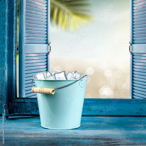 Ice cubes in metal containe and summer window sill background of free space for your decoration.  photo