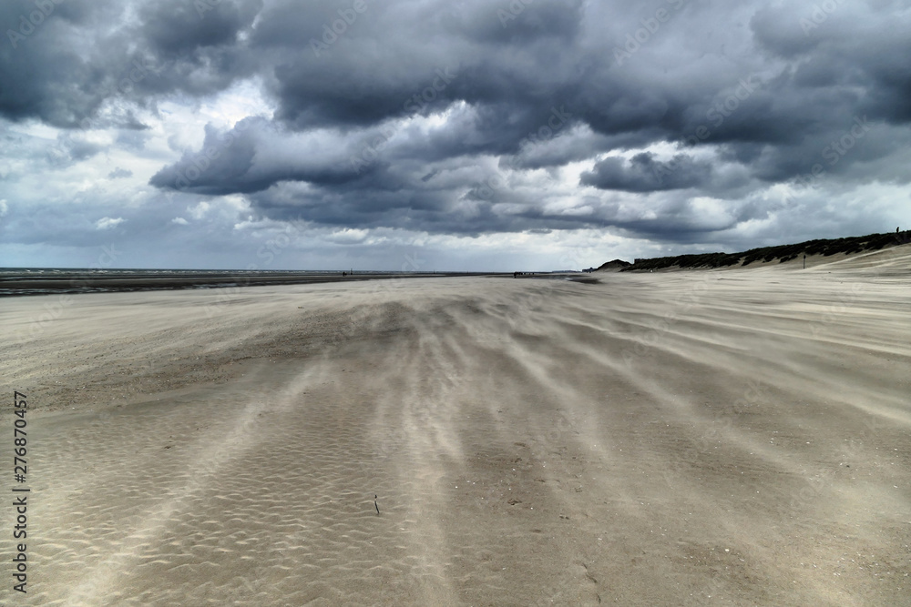 Impressive sand drifts and clouds during a hurricane at the Belgium coast Impressive sand drifts and clouds during a hurricane at the Belgium coast