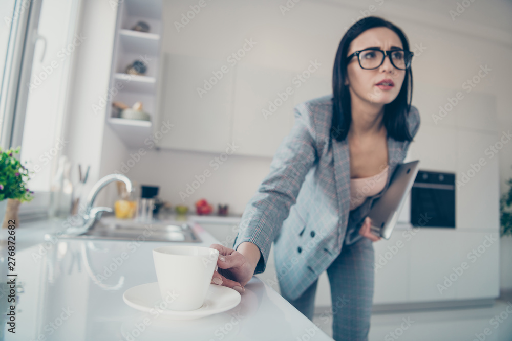 Portrait of beautiful stylish trendy pensive lady hold hand modern technology want mug beverage lean hurry late busy overworked dressed jacket blazers trousers pants apartment light Portrait of beautiful stylish trendy pensive lady hold hand modern technology want mug beverage lean hurry late busy overworked dressed jacket blazers trousers pants apartment light