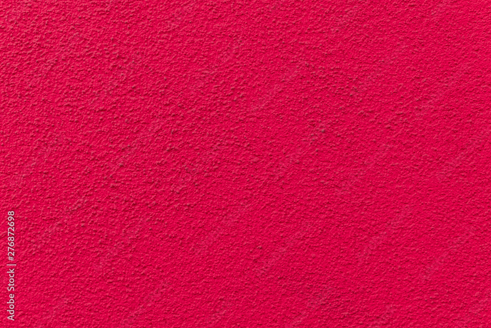 Fototapeta premium Pink painted cement wall, uneven concrete surface