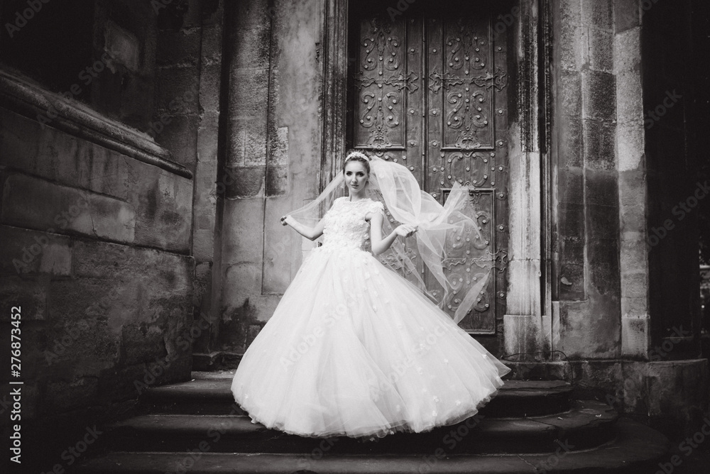 Bride poses near the old church Bride poses near the old church