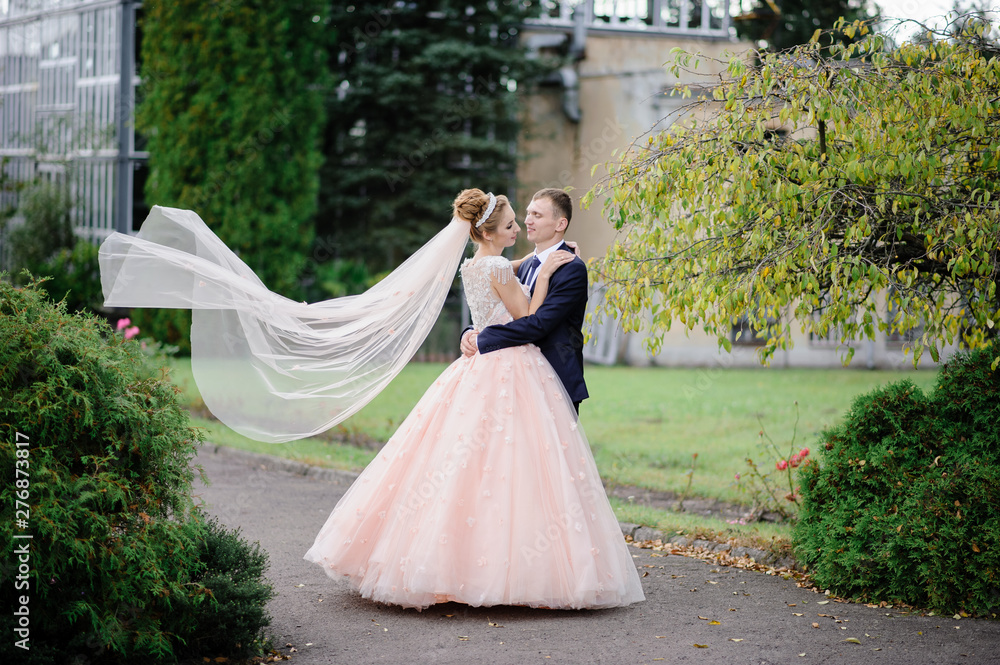 Fototapeta premium the groom whirls with his bride in the park