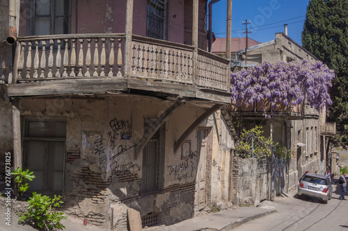 wooden balcony of pink house with beautiful flowers