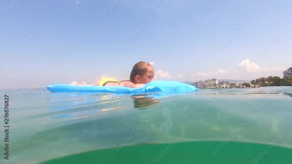 Cute child girl on air mattress in sea. Family vacation concept. Cute child girl on air mattress in sea. Family vacation concept.