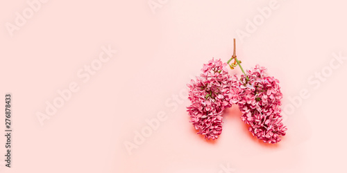 Medical concept of pink flowers in the shape of a lung on a light pink background with place for text. Flowering spring of lilac. Coronavirus, Covid-19 concept