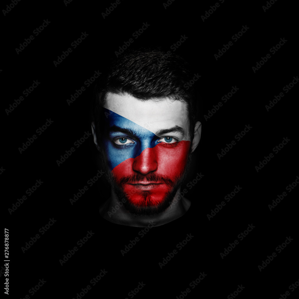 Flag of Czech Republic painted on a face of a man on black background.