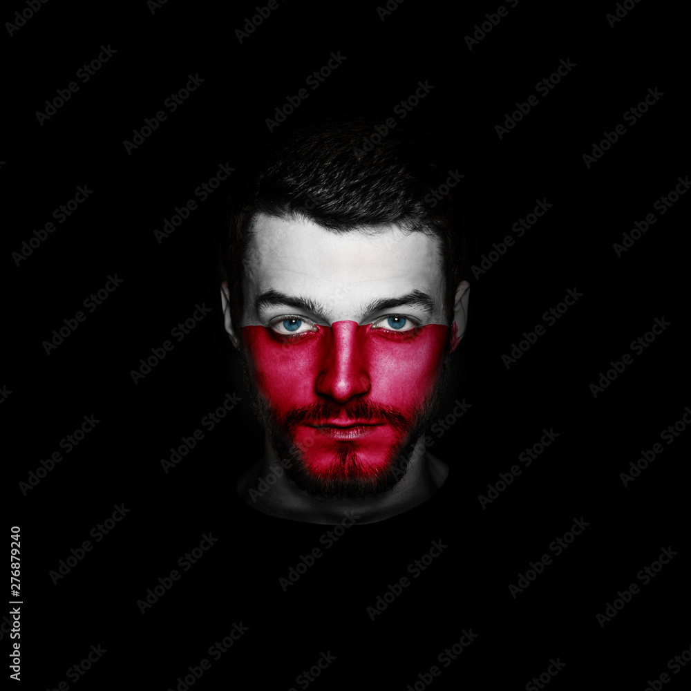 Flag of Poland painted on a face of a man on black background. Flag of Poland painted on a face of a man on black background.