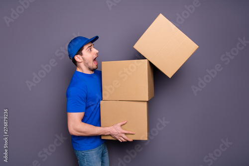 Close up photo profession yelling he him his deliveryboy hold hands large big heavy parcel boxes exhausted stressed catch upper breakable one wear blue t-shirt cap jeans denim isolated grey background photo