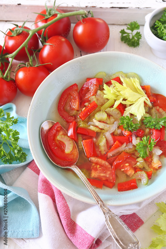 Summer vitamin detox soup with celery, red bell pepper and tomatoes, parsley garnish Summer vitamin detox soup with celery, red bell pepper and tomatoes, parsley garnish