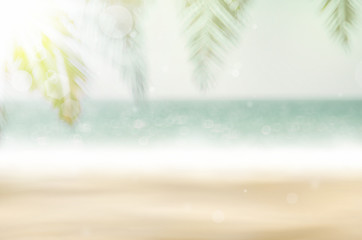 Blur beautiful nature green palm leaf on tropical beach with bokeh sun light wave abstract background.