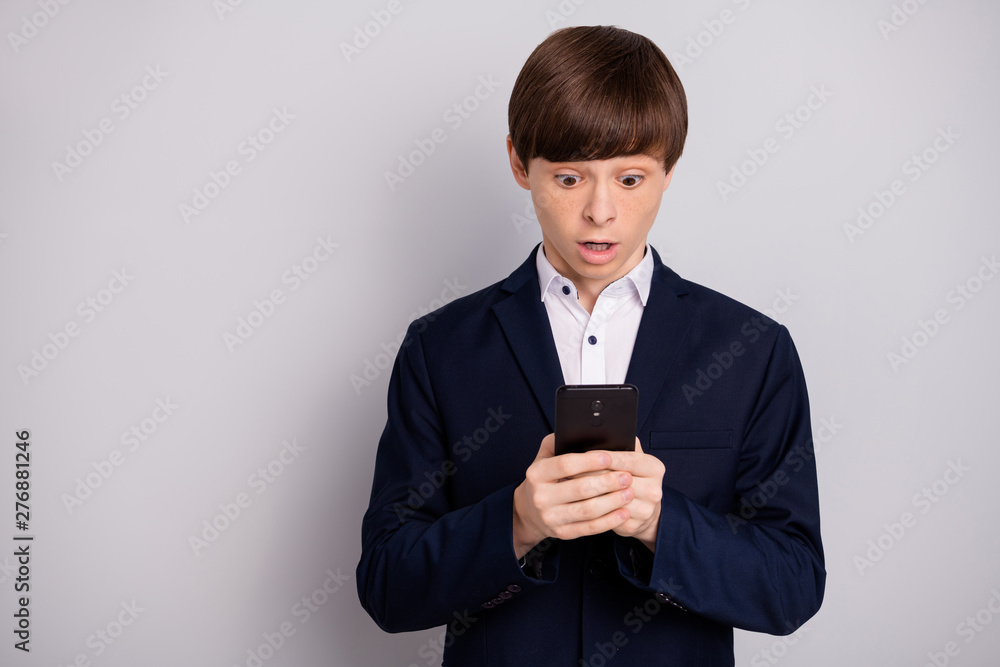 Portrait of lovely boy hold hand modern technology blog blogger astonished impressed unbelievable unexpected information new swear white black style shirt jacket isolated grey background Portrait of lovely boy hold hand modern technology blog blogger astonished impressed unbelievable unexpected information new swear white black style shirt jacket isolated grey background