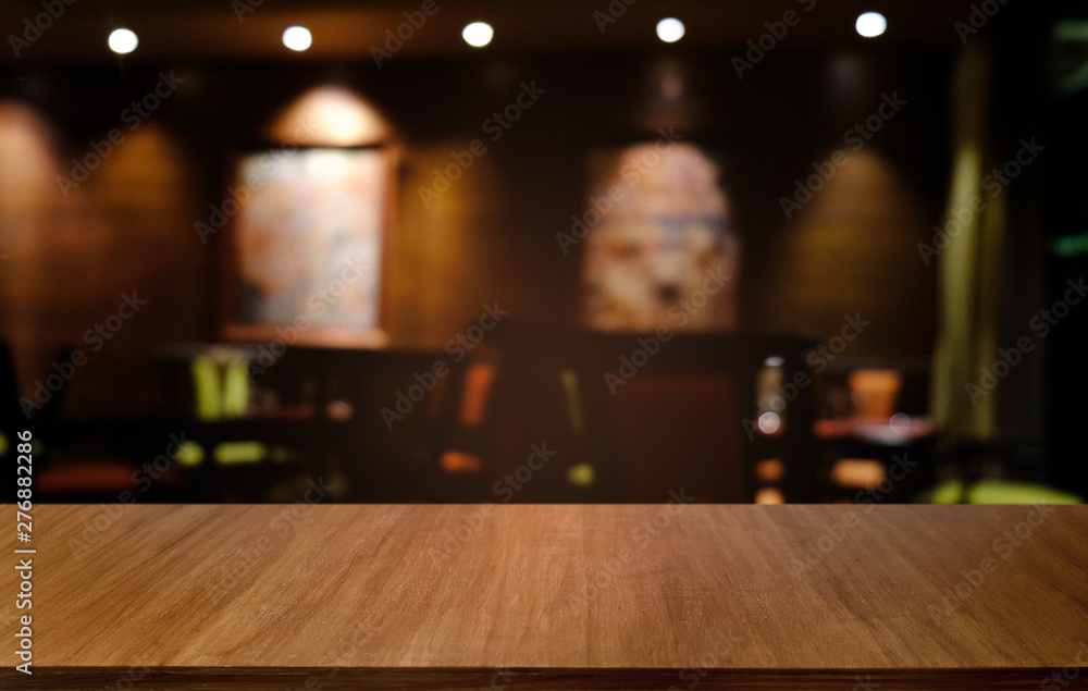 Empty dark wooden table in front of abstract blurred bokeh background of restaurant . can be used for display or montage your products.Mock up for space. Empty dark wooden table in front of abstract blurred bokeh background of restaurant . can be used for display or montage your products.Mock up for space.