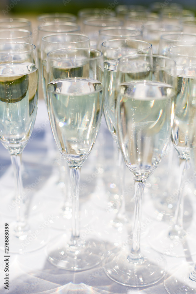 A lot of wine glasses in a row. Luxury glasses for alcohol. Wine glasses with wine on a table outside A lot of wine glasses in a row. Luxury glasses for alcohol. Wine glasses with wine on a table outside