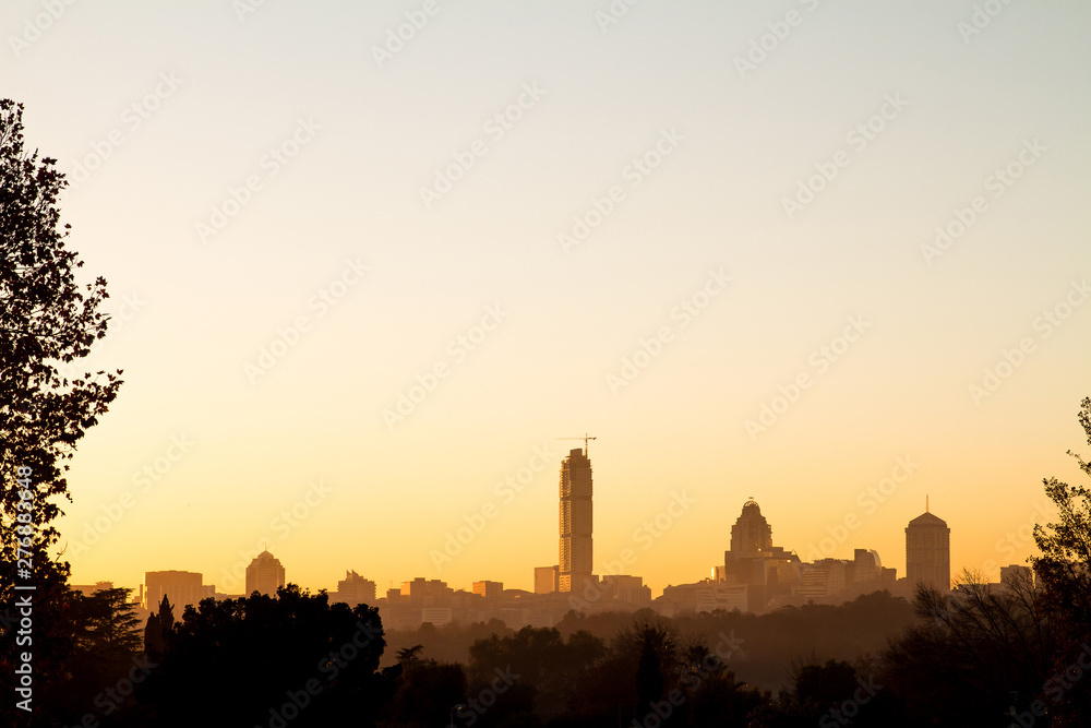 Fototapeta premium Wschód słońca nad panoramą Sandton w Johannesburgu, RPA, Afryce. Sylwetka budynków Sandton. Plac Sandton i Nelson Mandela to popularne miejsca turystyczne.