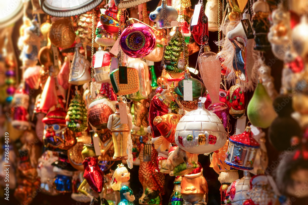 An abundance of colorful hanging holiday decorations on a Christmas market.