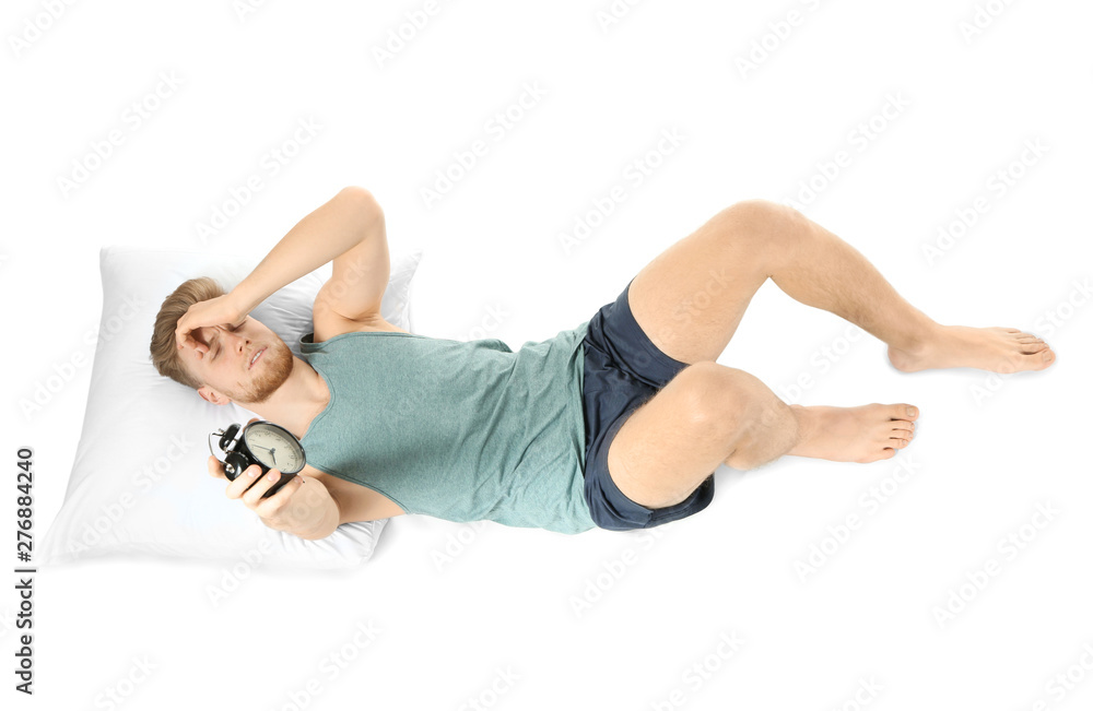 Sleepy man with alarm clock in bed Sleepy man with alarm clock in bed