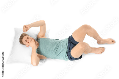 Handsome sleepy man in bed