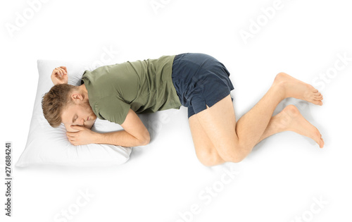Handsome sleeping man in bed