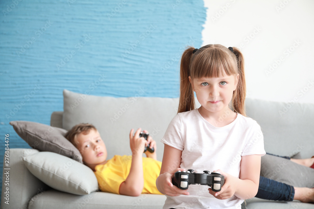 Little children with addiction to video games resting at home Little children with addiction to video games resting at home
