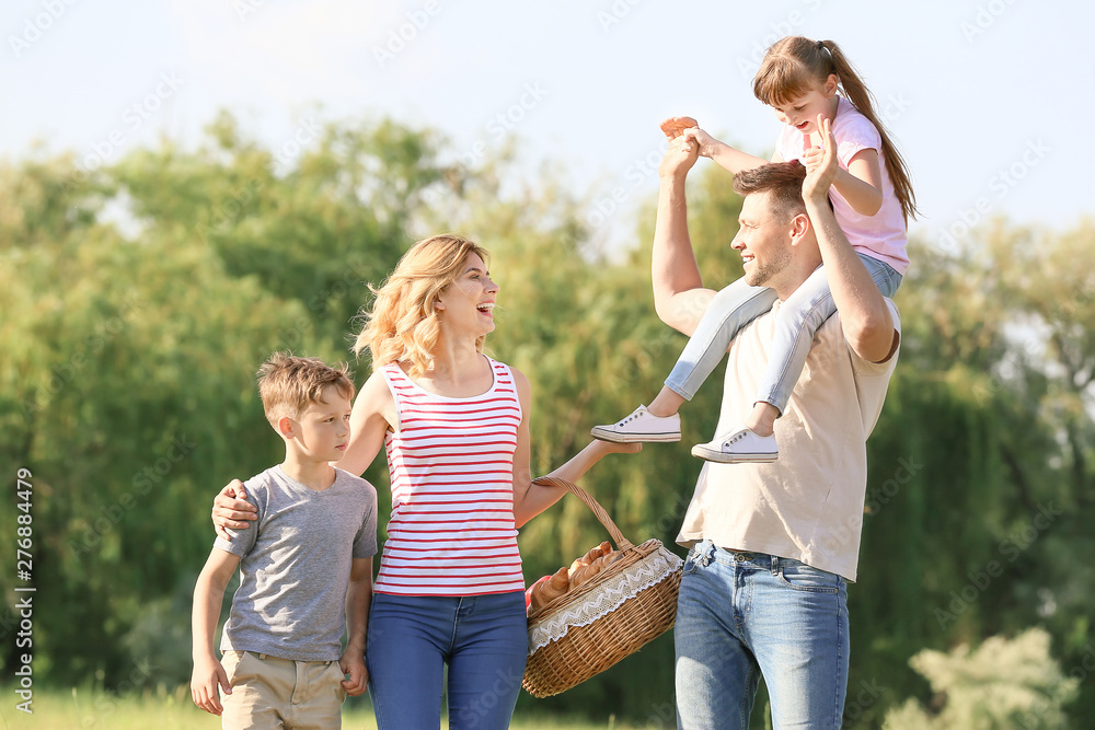 Fototapeta premium Happy family walking in park on summer day