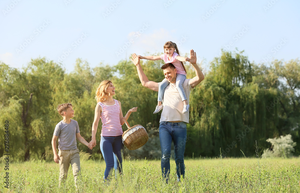 Fototapeta premium Happy family walking in park on summer day