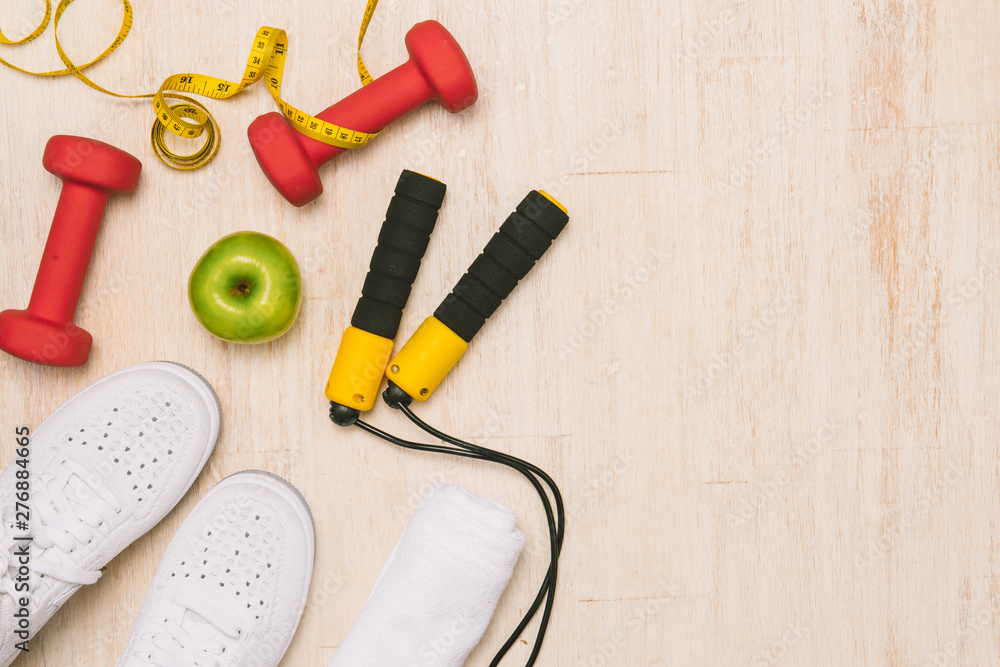 Sport shoes and water with set for activities on wooden floor. Sport shoes and water with set for activities on wooden floor.