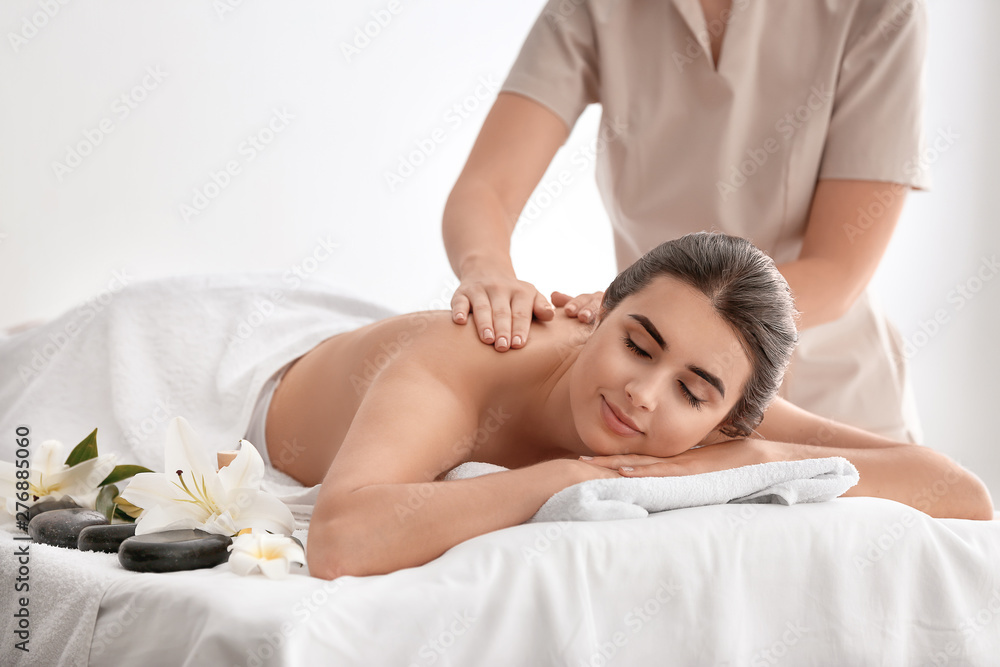 Beautiful young woman receiving massage in spa salon Beautiful young woman receiving massage in spa salon