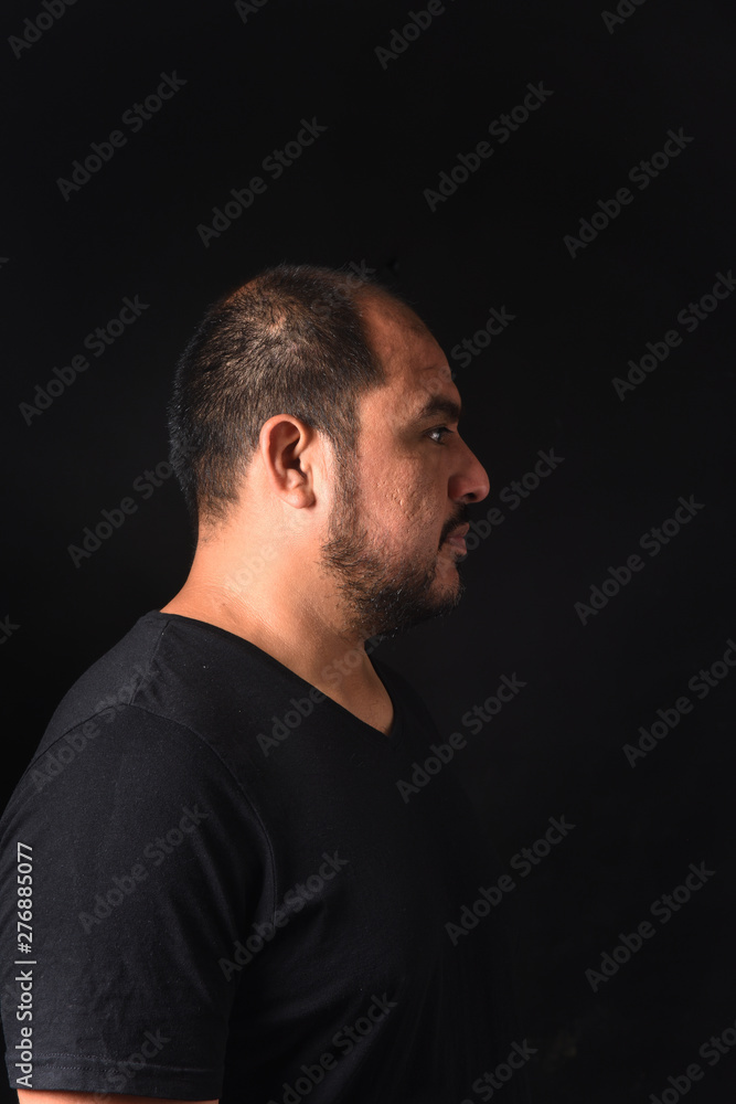 profile of a latin american man on black
