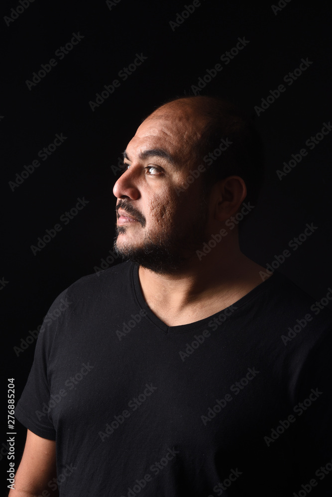 portrait of a latin american man on black background portrait of a latin american man on black background