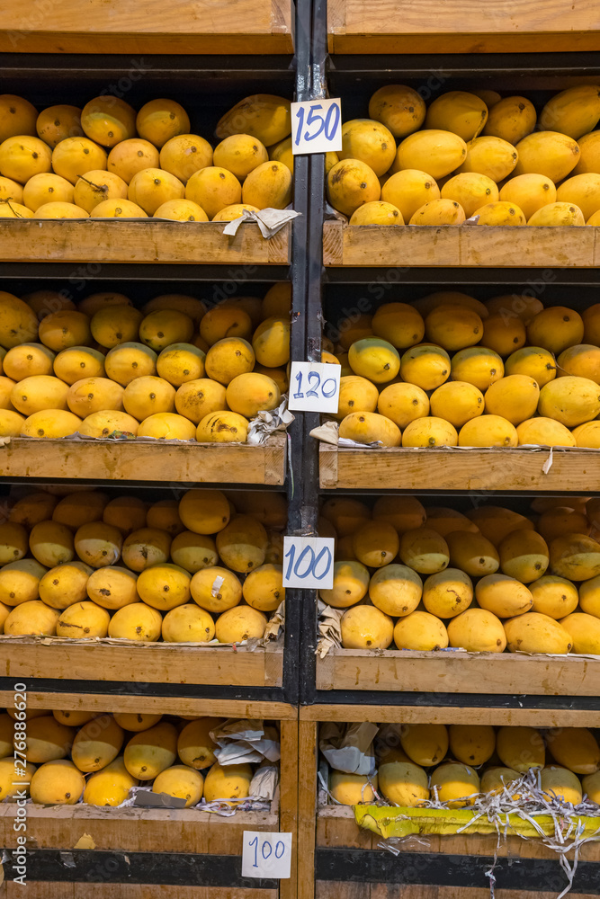 Pile of fresh yellow ripped Thai mango names Mamuang Kaew displayed on fruits stall shop