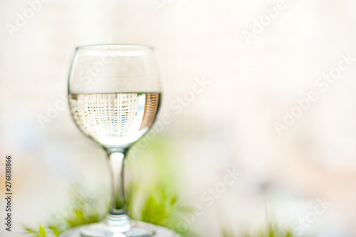 glass of water in hand on the background of the window in the daytime