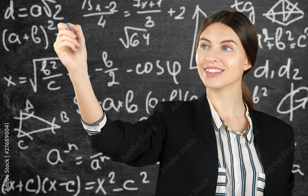 beautiful young businesswoman pointing at copy space isolated