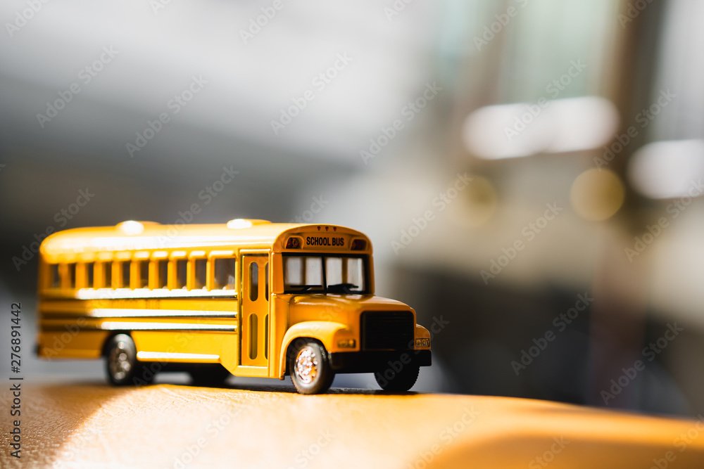 Miniature yellow school bus with sunlight