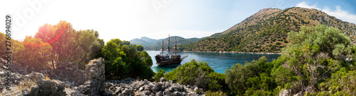 Canvas Print Pirate ship moored in a secluded bay with turquoise water at sunset, Oludeniz, T