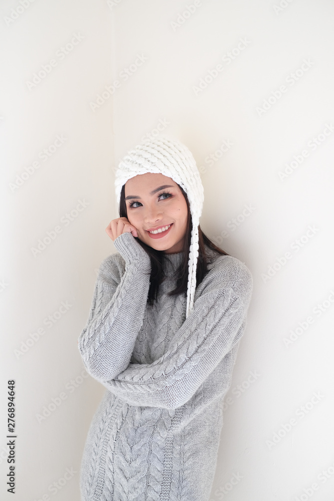 Asian girl, shot body length, is wearing a winter outfit with a cute emotion Asian girl, shot body length, is wearing a winter outfit with a cute emotion