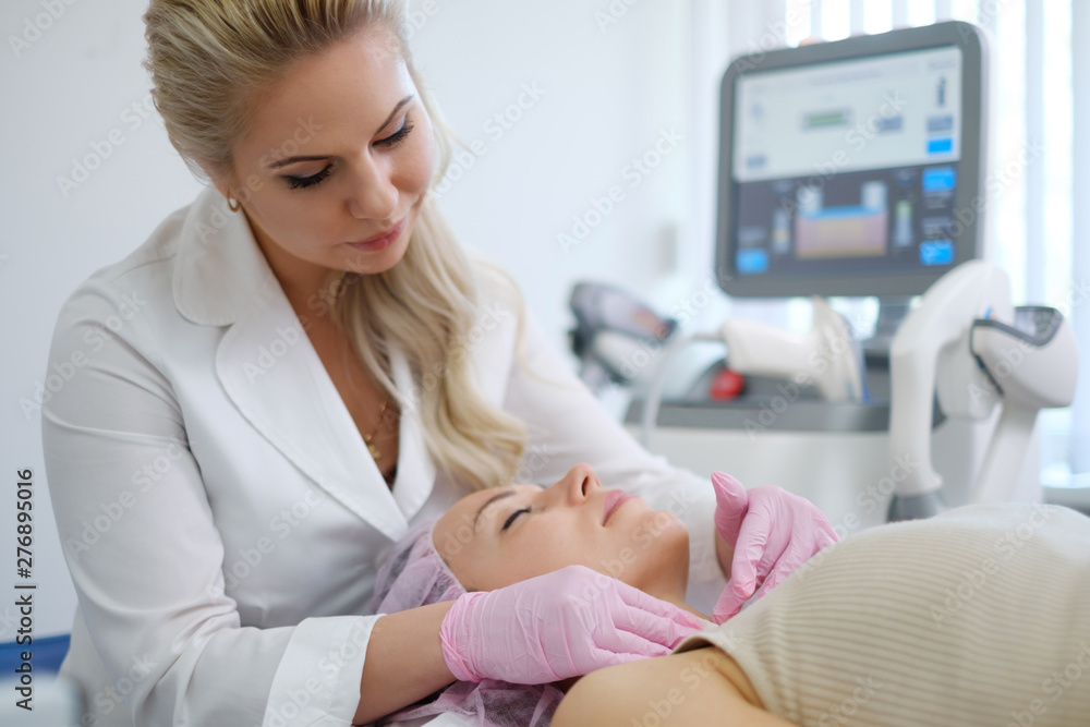 Fototapeta premium Woman getting treatment with aesthetic dermatology device
