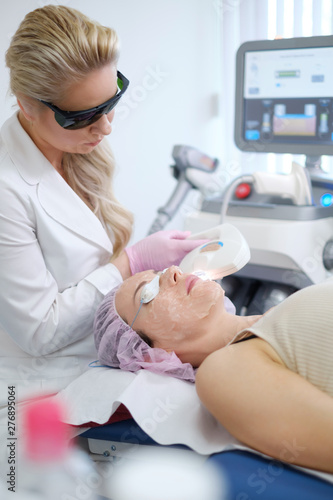 Woman getting treatment with aesthetic dermatology device