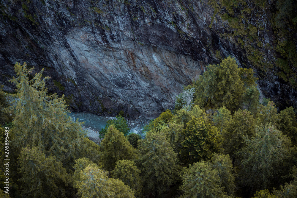 arial view into a wild gorge in the swiss alps