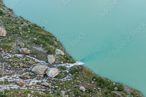 Triftsee mit Triftgletscher und mäanderndem Fluss in den Schweizer Alpen bei Gadmen photo