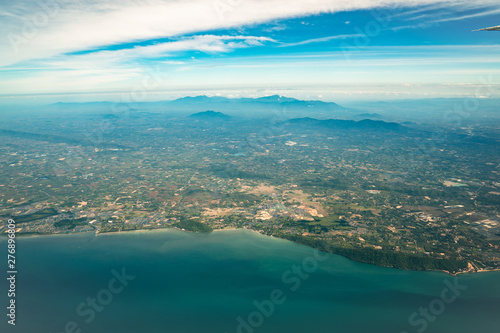 Photo shot from Jet Plane which shot the wide city beside the beach and sea in Middle of Thailand.