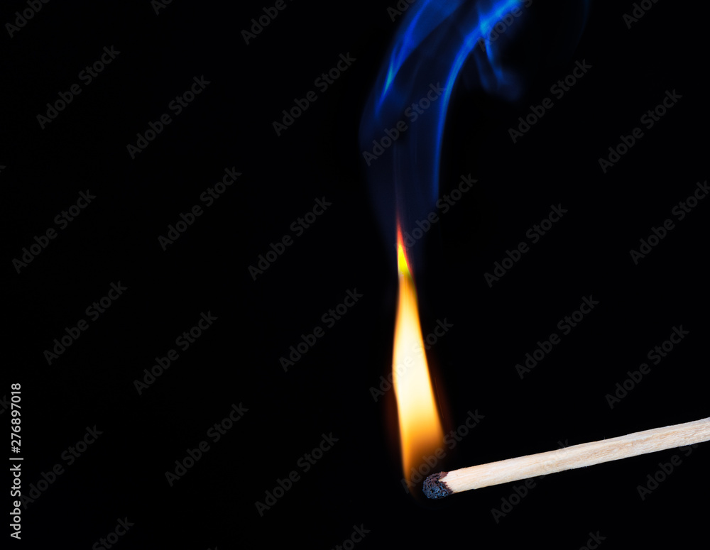 Burning wooden match with smoke over black background. Burning wooden match with smoke over black background.