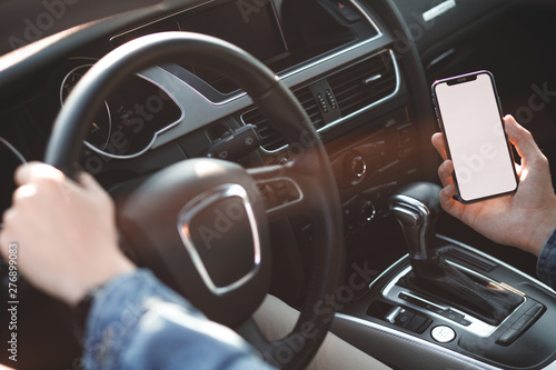 Fotografija Handsome man using mobile phone while driving.