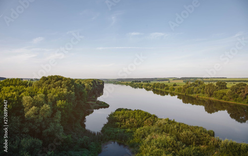 Fototapeta Naklejka Na Ścianę i Meble -  Beautiful natural scenery of river in tropical green forest with mountains in background, aerial view drone shot