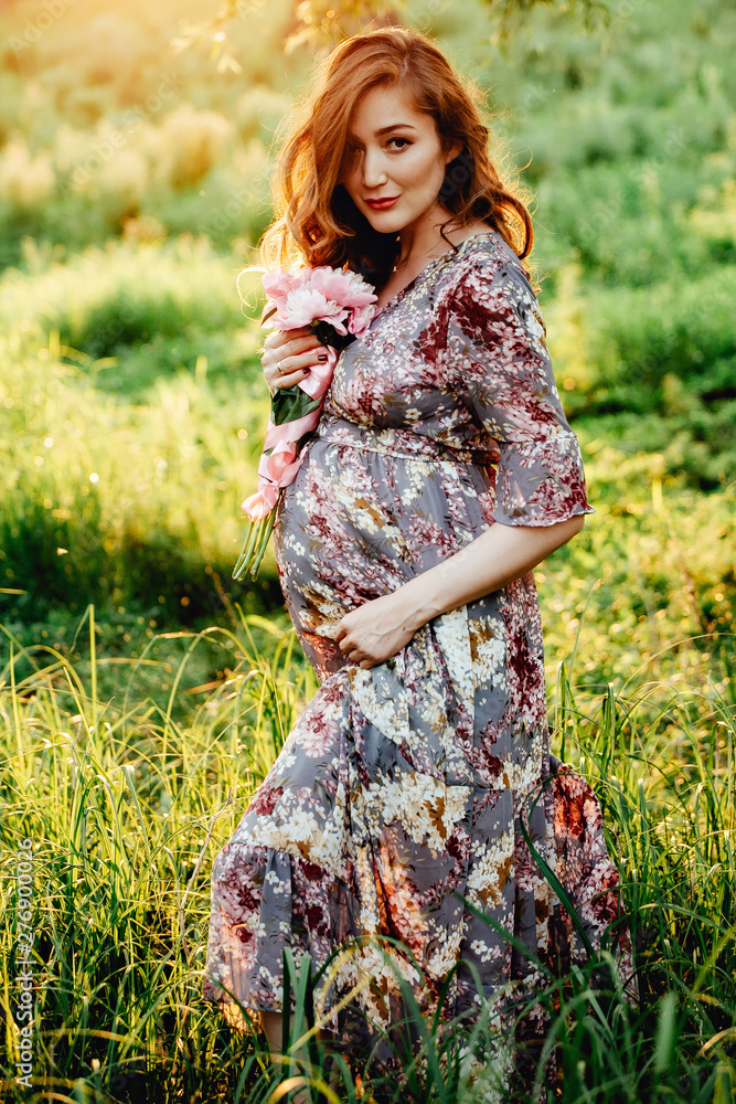 Pregnant woman feeling happy with new life at garden home while take care of her child. Pregnant woman feeling happy with new life at garden home while take care of her child.