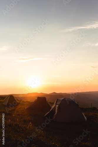 Camping tent in Mountains Morning sunrise orange Landscape Travel Lifestyle concept adventure vacations outdoor hiking gear equipment