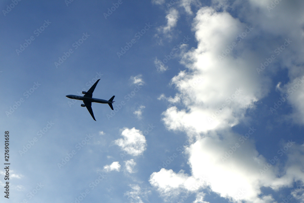 Airplane flying and clear blue sky with white clouds Airplane flying and clear blue sky with white clouds