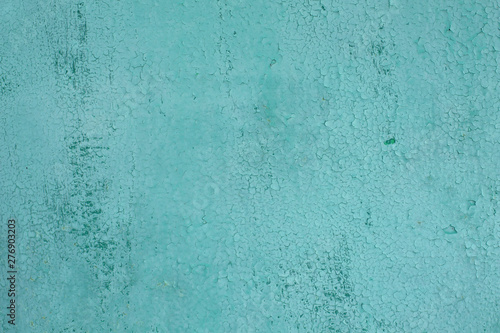 the texture of old turquoise paint with cracks.
