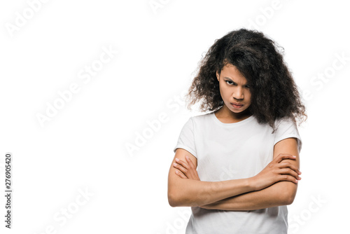 upset african american woman standing with crossed arms and looking at camera isolated on white © LIGHTFIELD STUDIOS